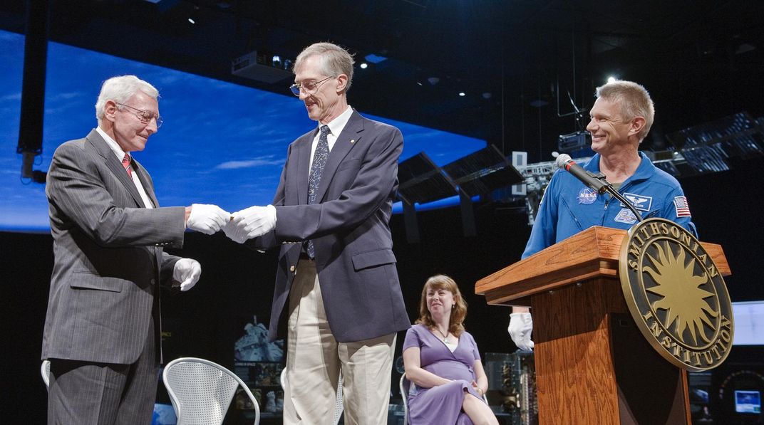 the Nobel Prize replica is handed off on stage