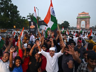 People in New Delhi celebrate India&#39;s successful landing of a spacecraft near the moon&#39;s south pole on Wednesday.
