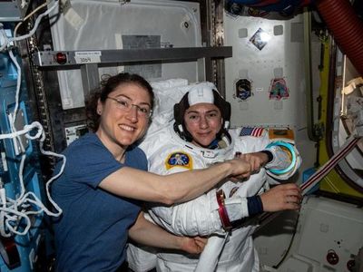 Christina Koch (left) poses for a portrait with Jessica Meir while preparing for their first spacewalk together.